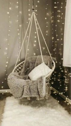 a hanging chair with lights in the background