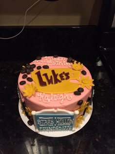 a birthday cake with the name luke's hollywood on it and sunflowers