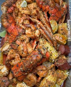 grilled shrimp and corn on the cob with lime wedges