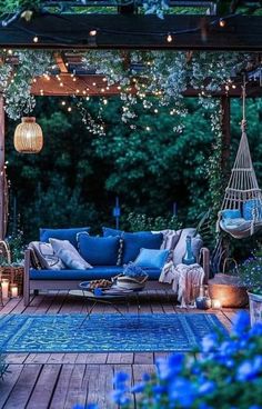 a blue couch sitting on top of a wooden deck