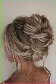 a woman with blonde hair styled into a low bun