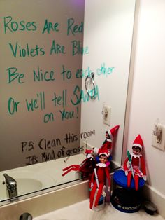 the elf in the bathroom is writing on the wall next to the sink and mirror