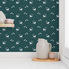 a teal wallpaper with white horses and flowers on it, next to a wooden shelf