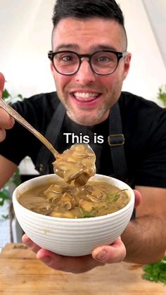 a man holding a spoon full of soup with the caption, this is me