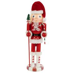 a christmas nutcracker figurine with a santa hat and holding a candy cane