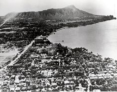 an aerial view of a city with mountains in the background