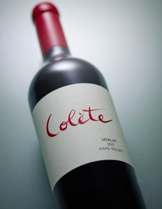 a bottle of red wine with the word colette on it's label sitting on a table