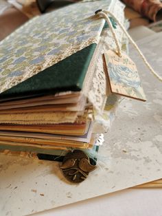 a pile of books sitting on top of a table next to a pair of scissors