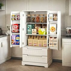 a kitchen with white cupboards and shelves filled with food, snacks and other items