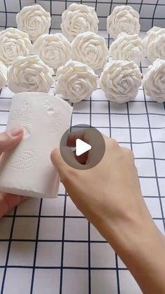 someone is making paper flowers out of toilet paper