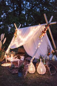 an outdoor area with lights and decorations on the ground, including a white tarp