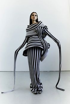 a woman dressed in black and white striped clothing