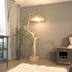 a living room with a lamp on the wall and a tree in the corner next to it