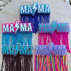 four different colored fringes with the word mamma on them are laying next to each other