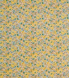 a yellow and green flowered fabric with small white flowers on the bottom half of it