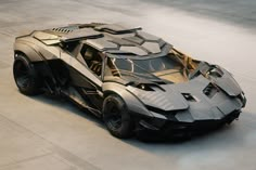 a batmobile is shown on the ground in an empty area with no one around it