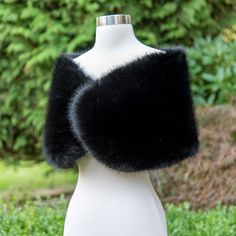 a white mannequin with black fur on it