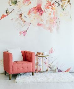 an image of a room with flowers on the wall and a chair in front of it