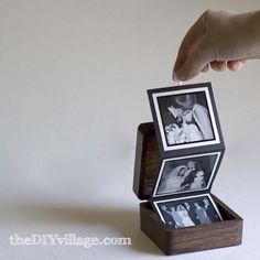 a hand is holding an open box with two pictures in it