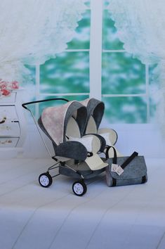 a baby stroller sitting in front of a window next to a pair of shoes