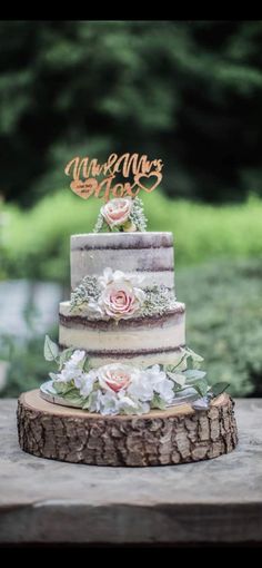 a wedding cake sitting on top of a wooden table