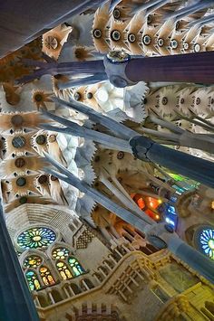 the interior of a cathedral with many stained glass windows