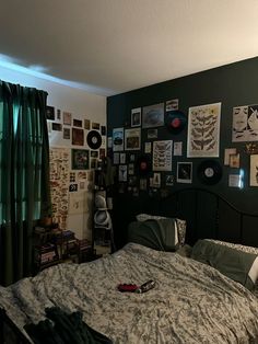 a bedroom with green walls and pictures on the wall