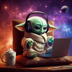 a baby yoda with headphones sitting in front of a laptop