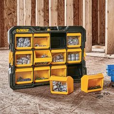 a toolbox filled with lots of tools on top of a hard wood floor next to blue containers