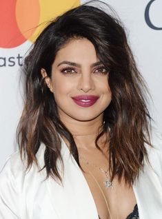 an image of a woman with long hair and purple lipstick on her lips at the billboard awards