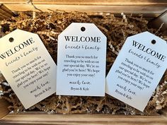 three welcome gift tags in a box with wood shavings on the bottom one says, welcome friends and family