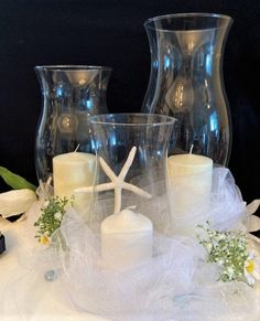 candles and vases are sitting on a table