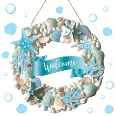 a welcome sign hanging from the side of a wreath with seashells and starfish