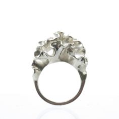 The top of this ring blooms into an intricately undulating surface, inspired by the frilly arms of a jellyfish. The ring is 3D printed in wax, then cast in silver using lost wax casting. Also available in brass, 14k gold, 18k gold, palladium, and platinum by special order.Our Florescence collection is inspired by the biomechanics of growing leaves and blooming flowers. Each piece emerges from a computational simulation of differential growth, a surface that grows at different rates in different Lost Wax Casting Rings, Lost Wax Casting Jewelry, Lost Wax Jewelry, Cnidaria, Cast Rings, Wax Ring, 3d Printed Jewelry, Wax Carving, Printed Jewelry