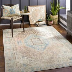 a living room area with a rug, chair and other items on the hardwood floor