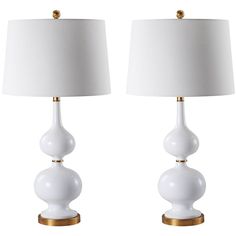 two white table lamps with gold accents on each one and a white shade on the other