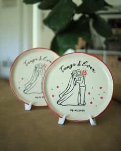 two personalized wedding plates are sitting on a table