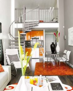 a living room filled with furniture and a spiral staircase