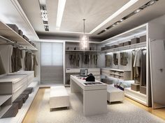 a large walk in closet filled with lots of white furniture and lighting hanging from the ceiling