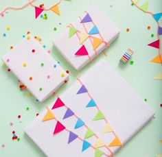 three pieces of cake sitting on top of a table covered in confetti and streamers