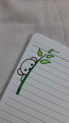 a notepad with a drawing of a monkey holding a plant on it's side