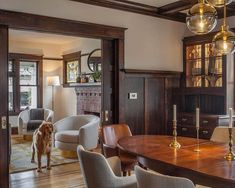 a dog is standing in the middle of a large dining room with wood paneling