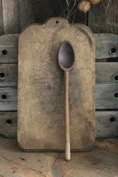 a wooden spoon sitting on top of a cutting board