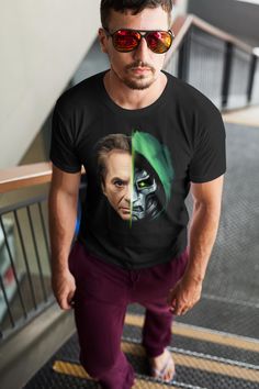 a man wearing sunglasses and a t - shirt with an image of dracula on it