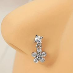 a pair of diamond earrings sitting on top of a mannequin's head