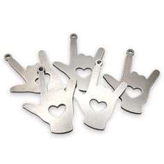 six metal bottle openers with hearts cut out of them