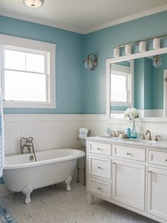 a bathroom with blue walls and white fixtures