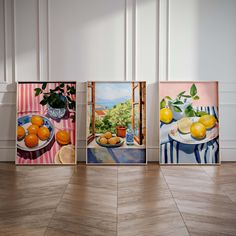 three paintings of lemons and oranges are on display