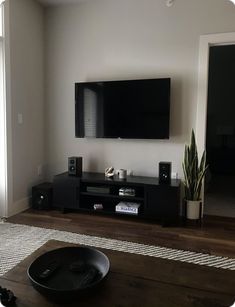 a flat screen tv sitting on top of a wooden table