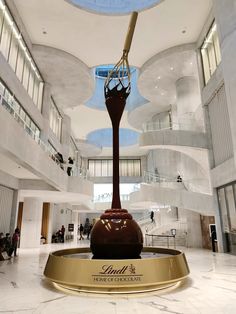 a large clock in the middle of a lobby